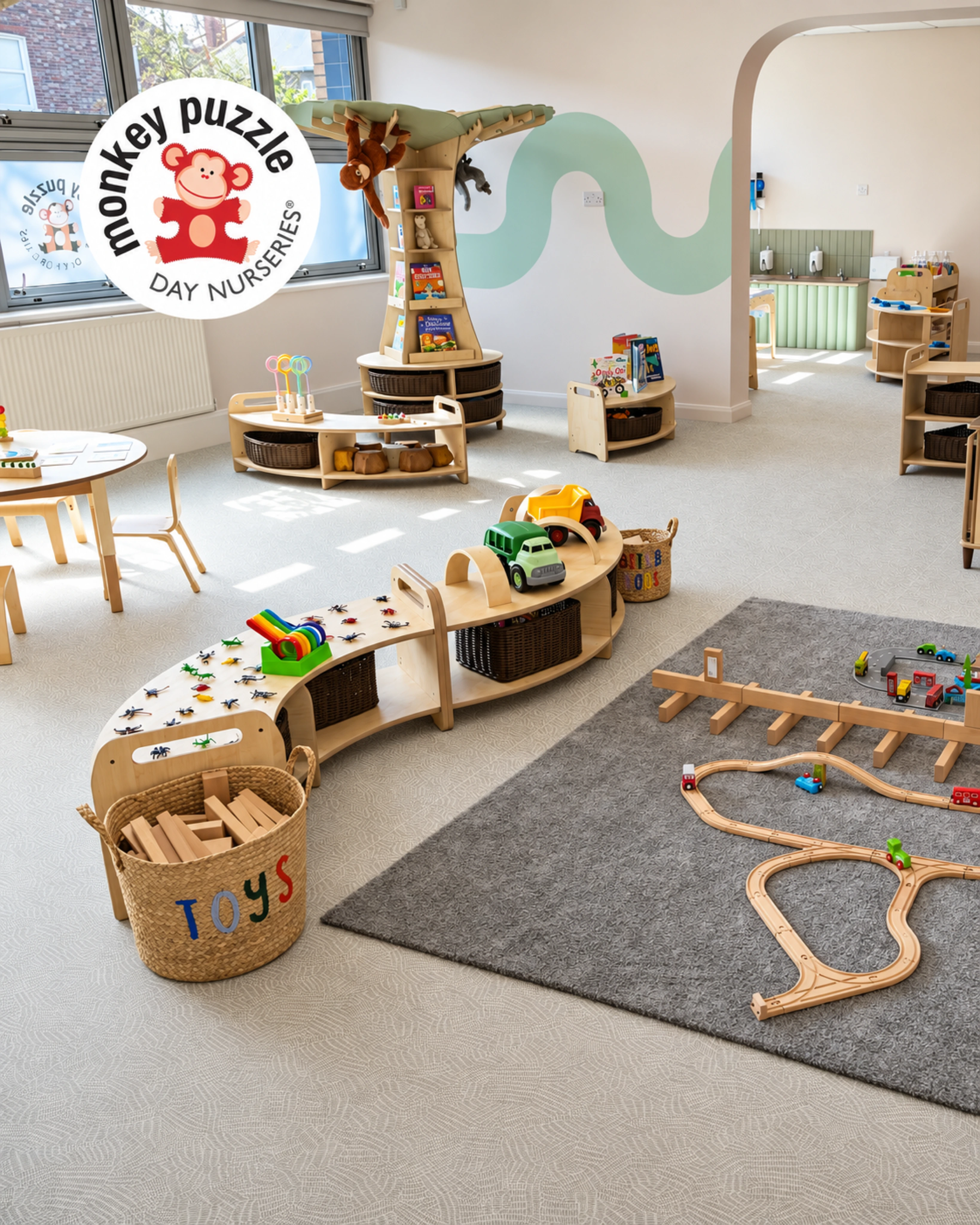 Nursery activity room with curved timber shelving and a painted wave detail