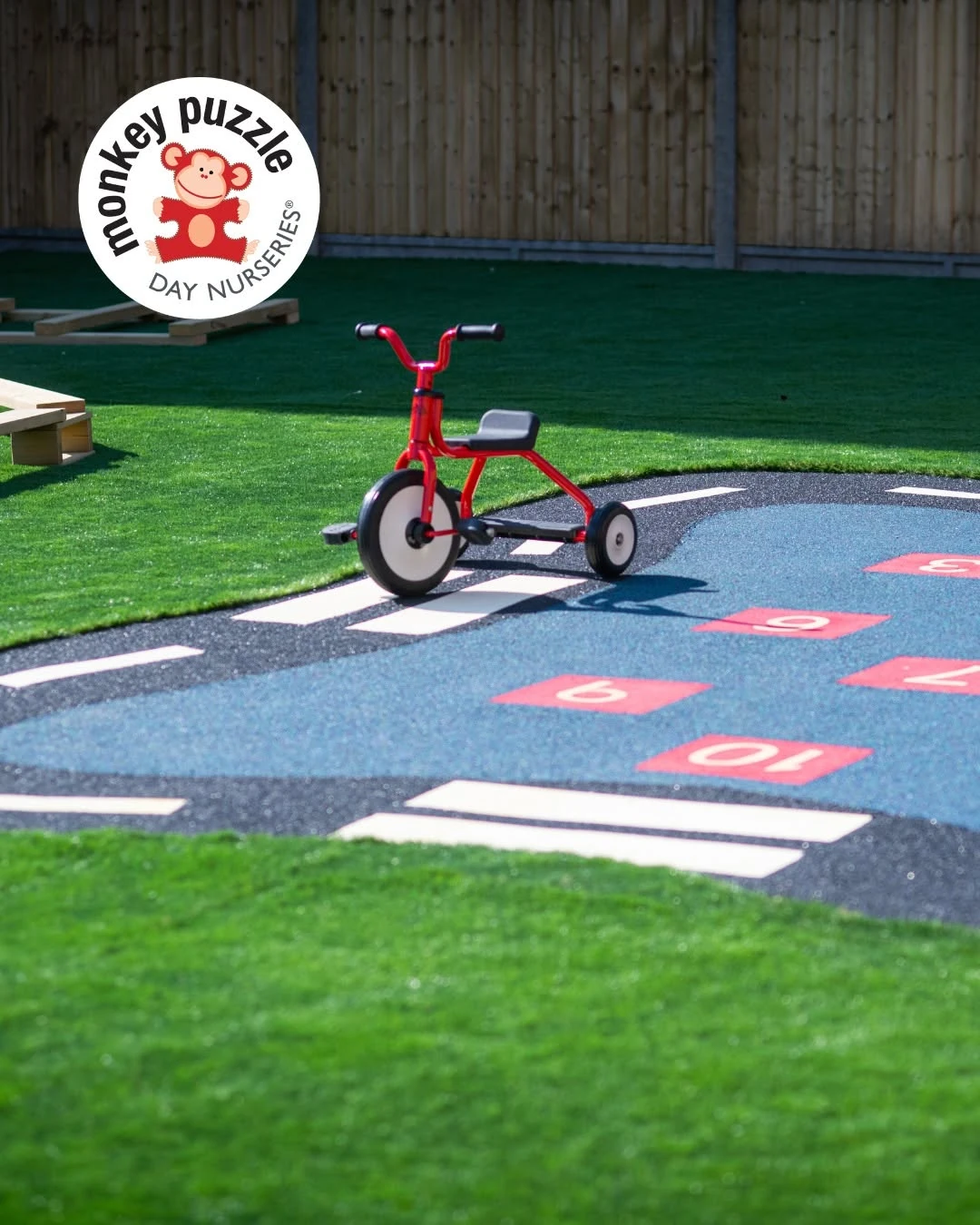 Tricycle and painted play markings in the nursery garden