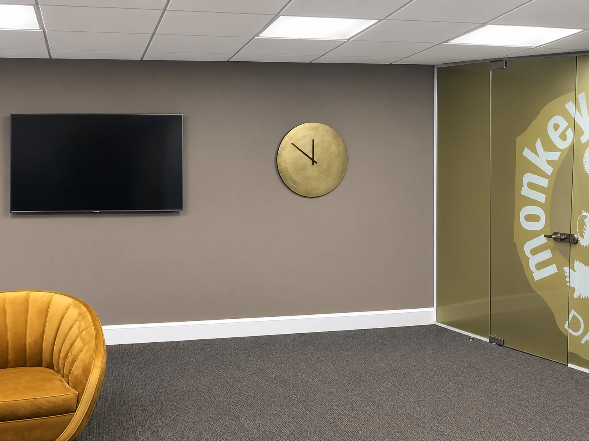 Reception seating beside the branded glazed partition.