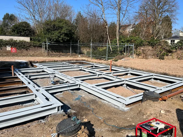 Early works: the ground-level steel structure and drainage routes.