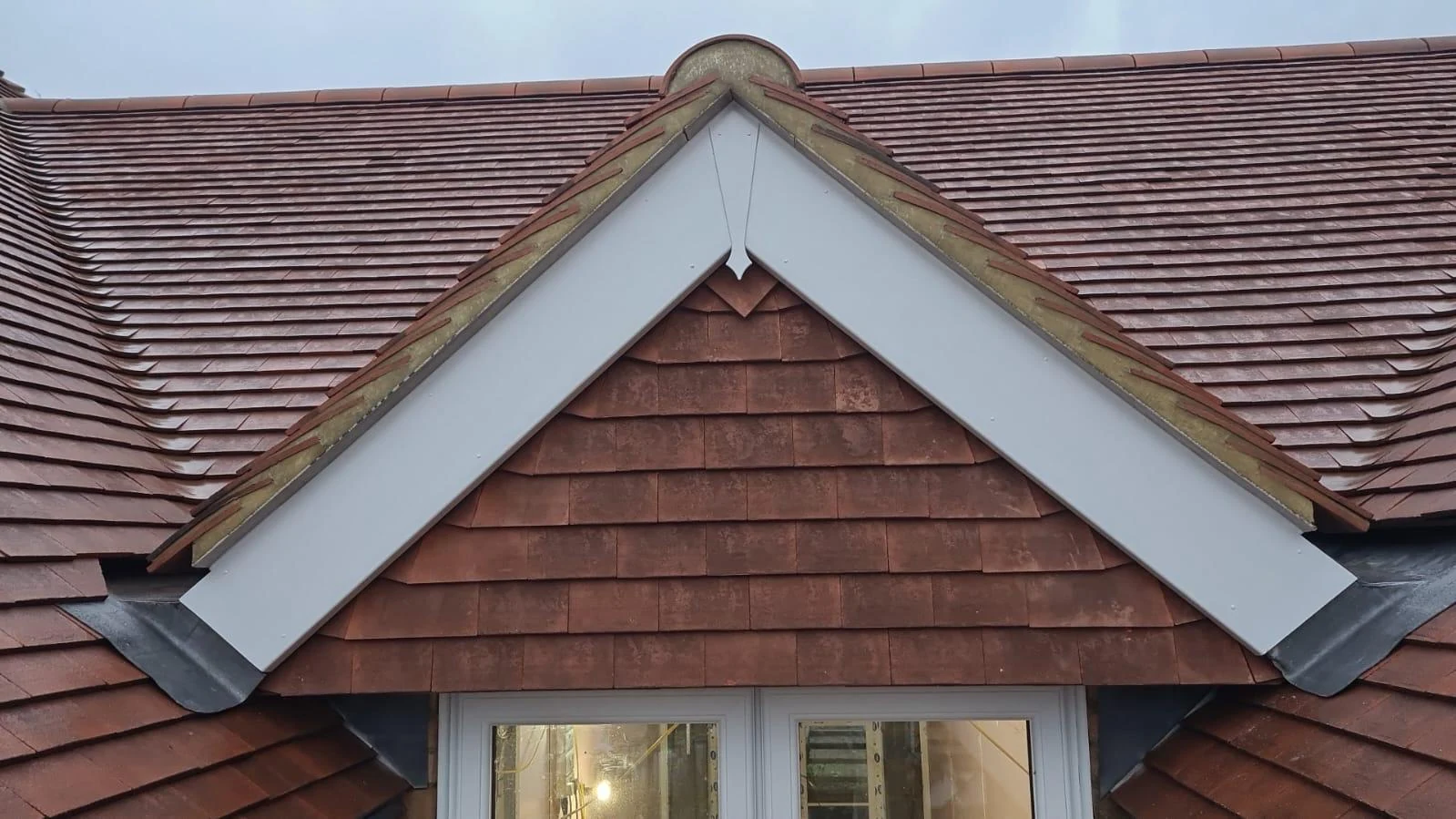 The tiled roof and gable detail.