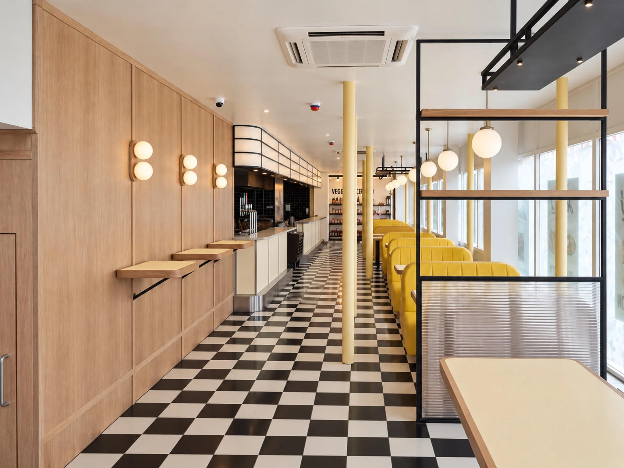 Rudy’s Vegan Restaurant: timber finishes, yellow booths and a chequerboard floor.