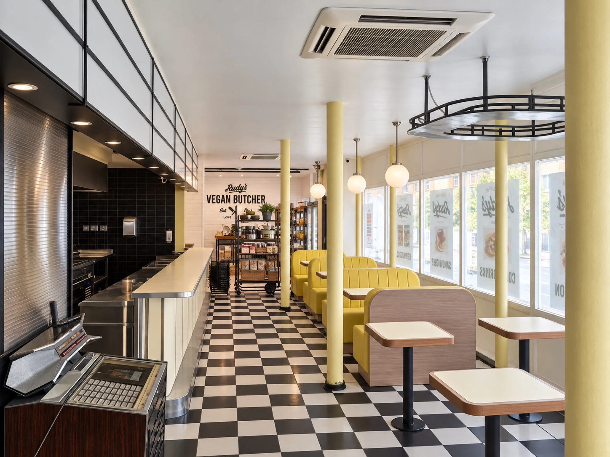 The counter and dining tables within the restaurant.