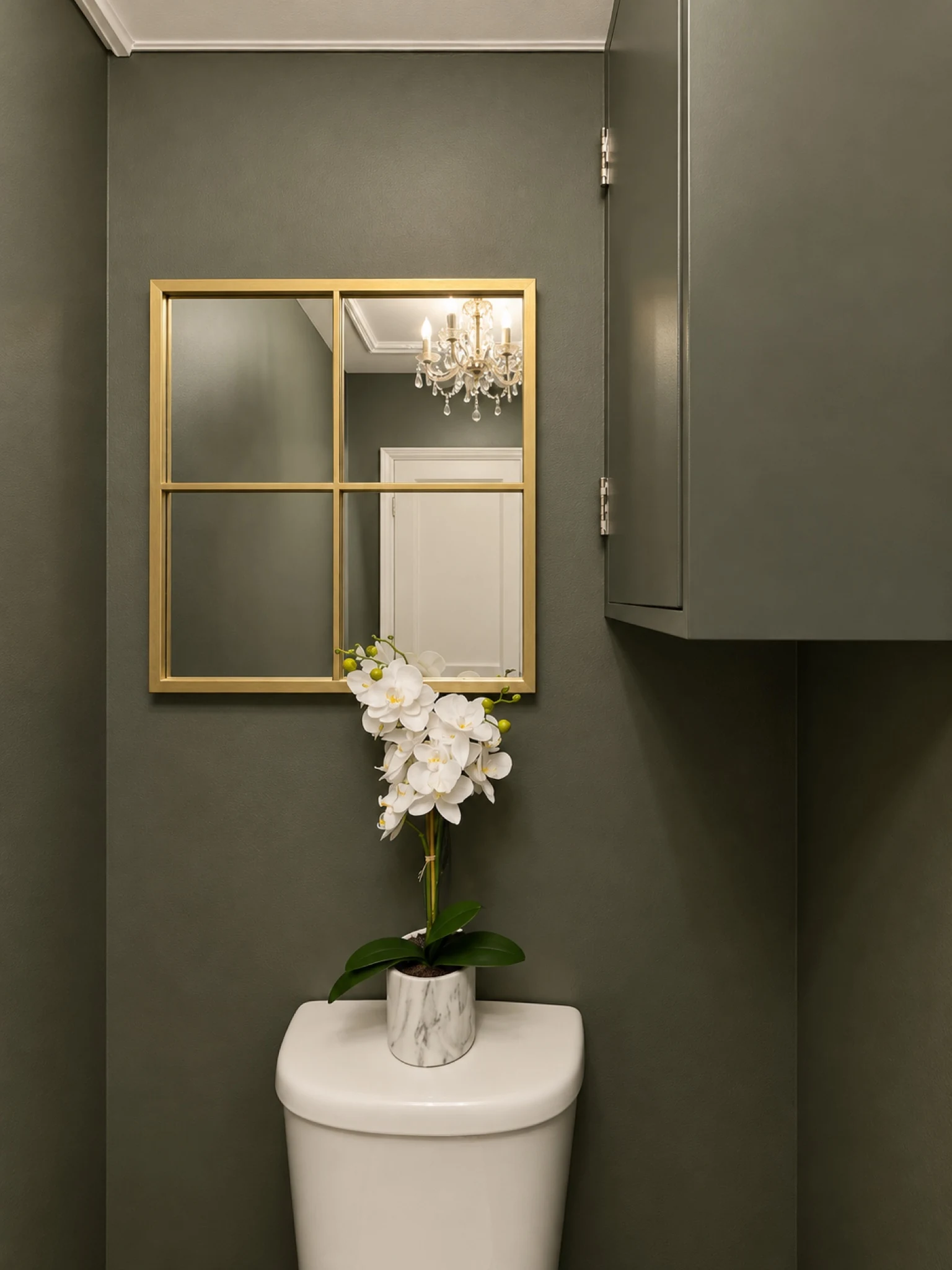The finished cloakroom with a wall-mounted basin and mirror.