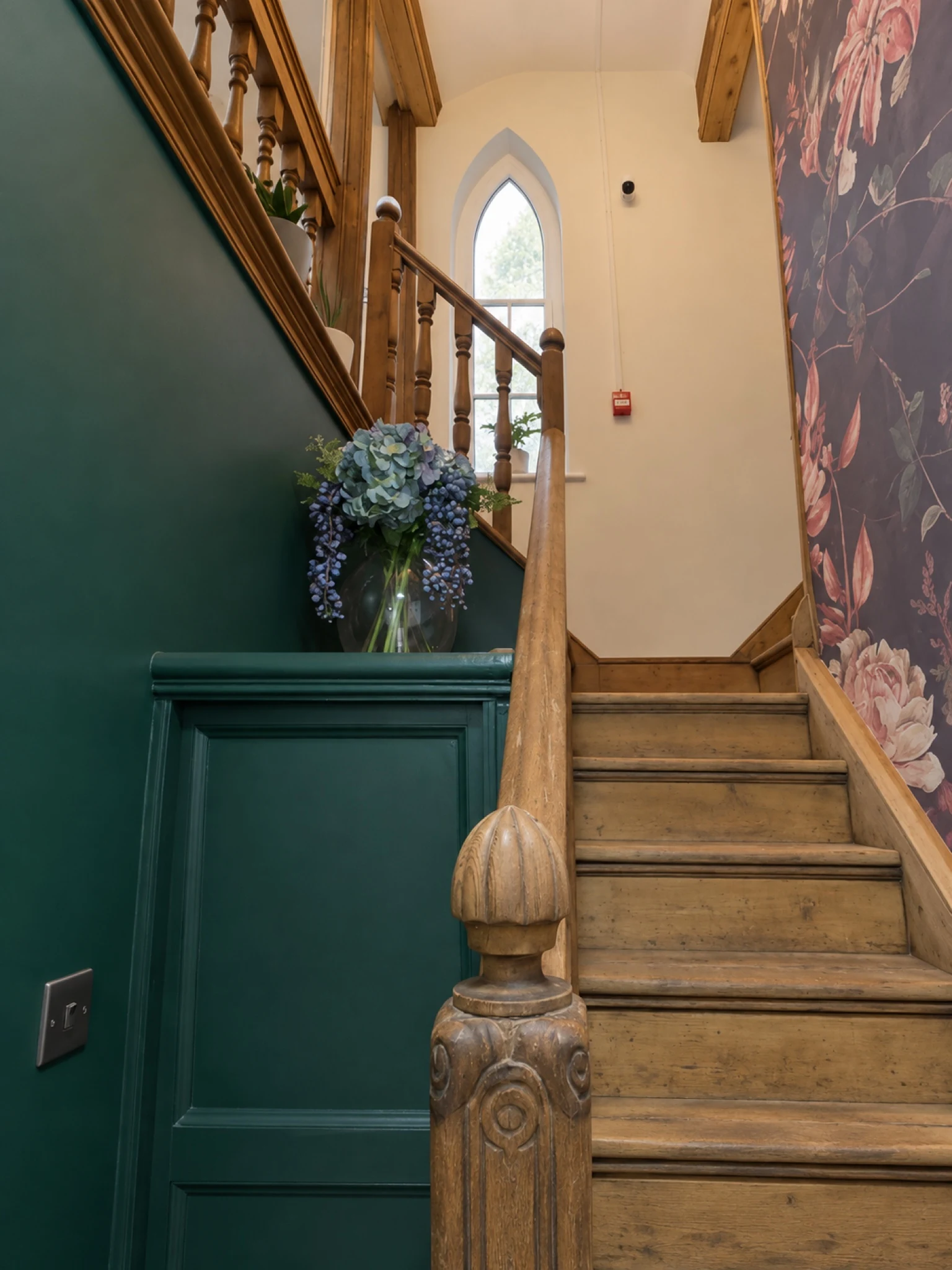 Timber stairs and balustrades alongside green panelling.