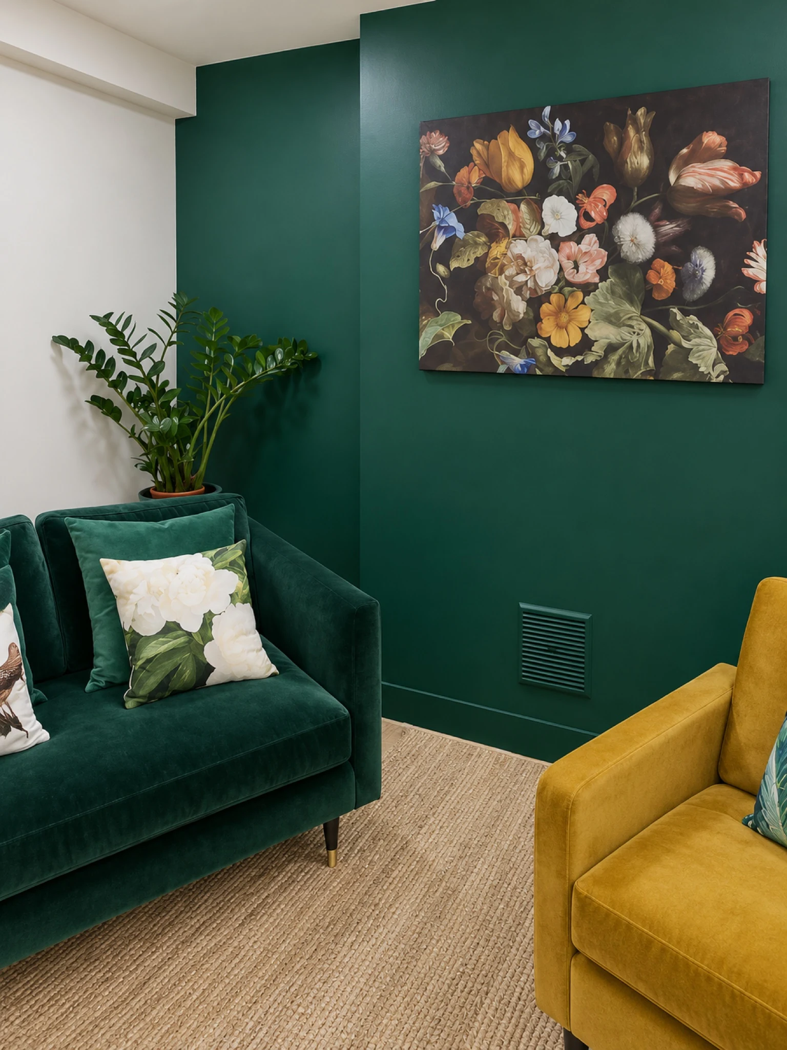 Deep green wall panelling and upholstered seating in a finished room.